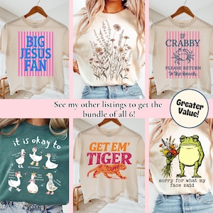 May include: Collection of six graphic t-shirts. Designs include "BIG JESUS FAN", floral sprigs, "IF CRABBY PLEASE RETURN to the beach", ducks, a tiger, and a frog holding flowers. The text "See my other listings to get the bundle of all 6!" is also present.