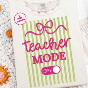 May include: Cream-colored t-shirt with a pink bow and the words "teacher MODE OFF" in pink. The design includes green vertical stripes. A small pink circle indicates "3 PNGs Included". A delicate necklace is visible.