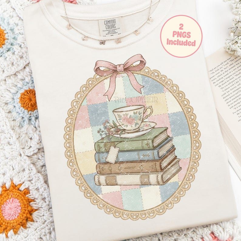 May include: A cream-coloured Comfort Colors sweatshirt featuring a floral teacup and book graphic. The design includes a stack of books, a teacup, and the text "The Sopheir" within a decorative frame. A pink bow and a butterfly necklace are also visible.