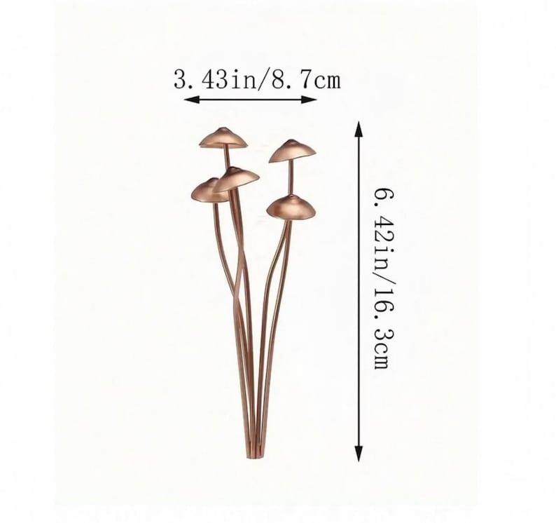 May include: A cluster of copper-colored mushroom-shaped decorative objects. The mushrooms are 3.43 inches wide (8.7 cm) and 6.42 inches tall (16.3 cm). The stems are thin and curved, and the caps are rounded and slightly flared.