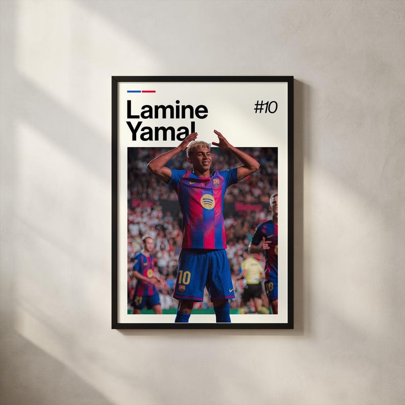 May include: Framed poster featuring a soccer player in a blue and red jersey with the number 10. The player is raising his arms in celebration. The poster includes the name "Lamine Yamal" and the number "#10" in a bold font.