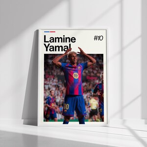 May include: A framed poster featuring a soccer player in a blue and red striped jersey, with the name "Lamine Yamal" and the number "10" displayed. The player is celebrating with arms raised. The background shows a stadium filled with spectators.