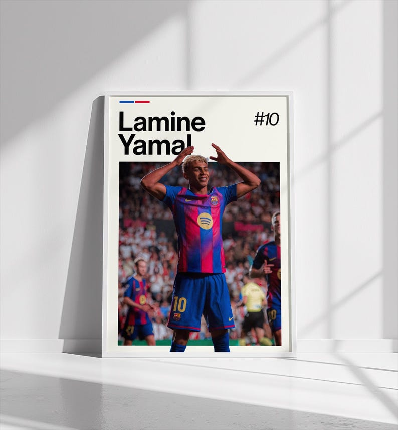 May include: A framed poster featuring a soccer player in a blue and red striped jersey, with the name "Lamine Yamal" and the number "10" displayed. The player is celebrating with arms raised. The background shows a stadium filled with spectators.