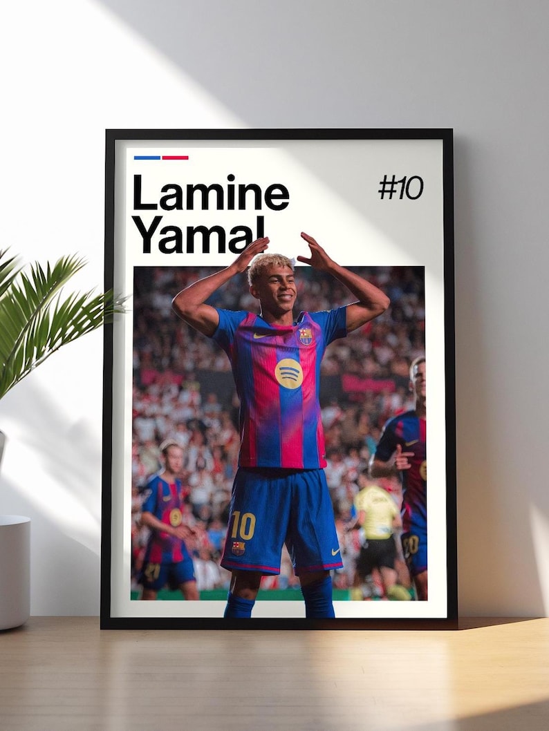 May include: Framed poster featuring Lamine Yamal in a Barcelona soccer uniform. The poster has a white background with the player's name and the number 10. The player is wearing a blue and red striped jersey and blue shorts, with his arms raised.