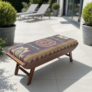 Handmade wooden upholstered kilim bench placed on outdoor patio seating area