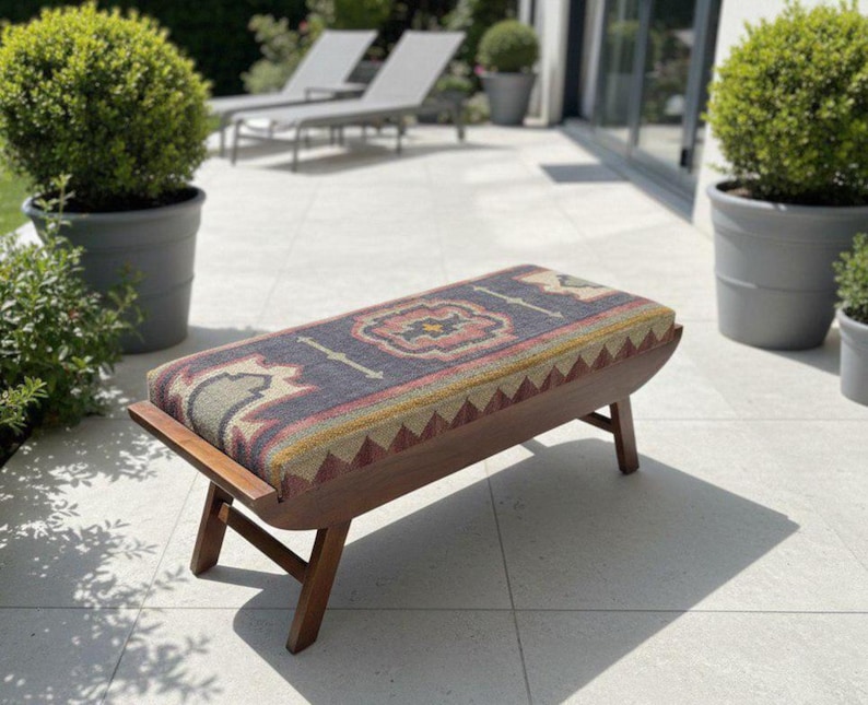 Handmade wooden upholstered kilim bench placed on outdoor patio seating area