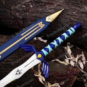 May include: A sword with a silver blade featuring a black triangular emblem, a blue and light blue wrapped handle, and a blue crossguard with a yellow accent. The matching blue scabbard has gold-colored geometric details and a gold-colored tip.