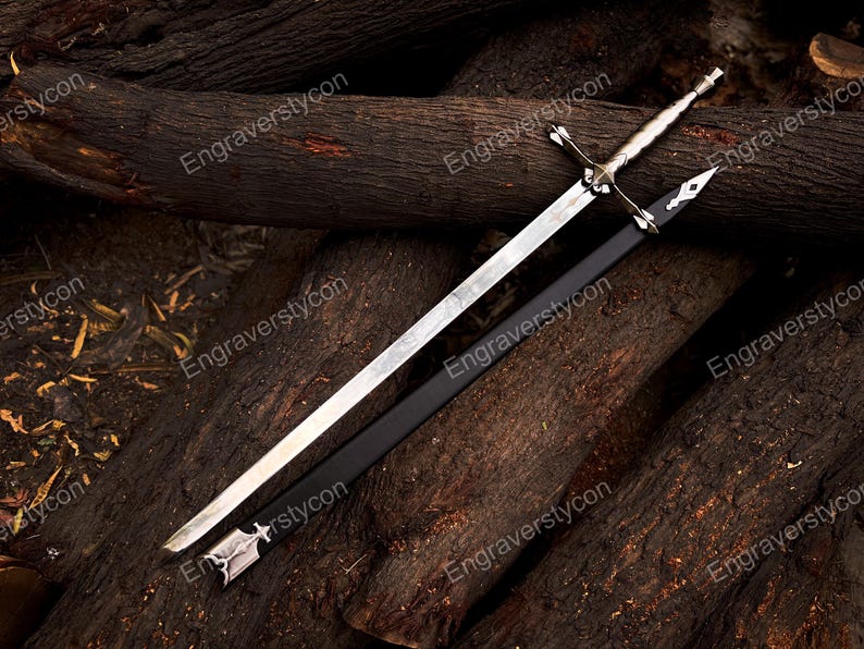 May include: A silver-toned metal sword with a cross-shaped guard and a textured handle, accompanied by a black scabbard featuring silver-colored metal accents at the tip and throat. The blade is straight, double-edged, and tapers to a sharp point.