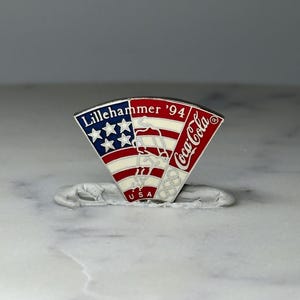 Lot - A Collection of Lillehammer 1994 Olympic Pins, of a Boy & Girl