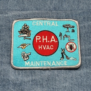 May include: Embroidered patch with a light blue background and white border. The patch features the words "CENTRAL MAINTENANCE" and "P.H.A. HVAC" in white and red. It also includes various illustrations related to maintenance work.