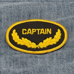 Captain collectable patch: iron-on black and gold oval - vintage accessory