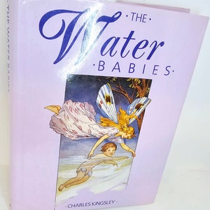 May include: A book cover with a purple background and a whimsical illustration of a fairy with wings and a child swimming in water. The title of the book is "The Water Babies" by Charles Kingsley.