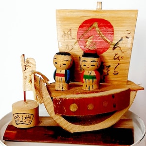 Vintage Japanese Miniature Wooden Kokeshi doll pair red blue on tiny boat handpainted wood turned bamboo signs