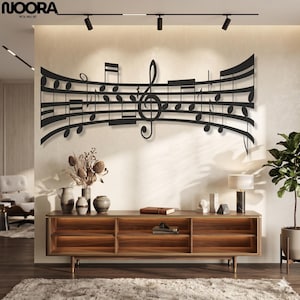 May include: A black metal wall art piece featuring a horizontal musical staff with various notes and a prominent treble clef in the center. The design is curved and mounted on a wall, displaying a continuous flow of musical notation symbols.