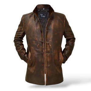 May include: A brown leather jacket with a distressed finish. The jacket has a button-up front, a collar, and two front pockets. The label inside the jacket reads "Real Leather".