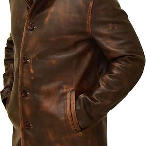 May include: A brown leather jacket with a classic design. The jacket features a button-up front, a collared neckline, and two front pockets. The leather has a distressed appearance, giving it a vintage look. The jacket is a medium length, reaching the mid-thigh.