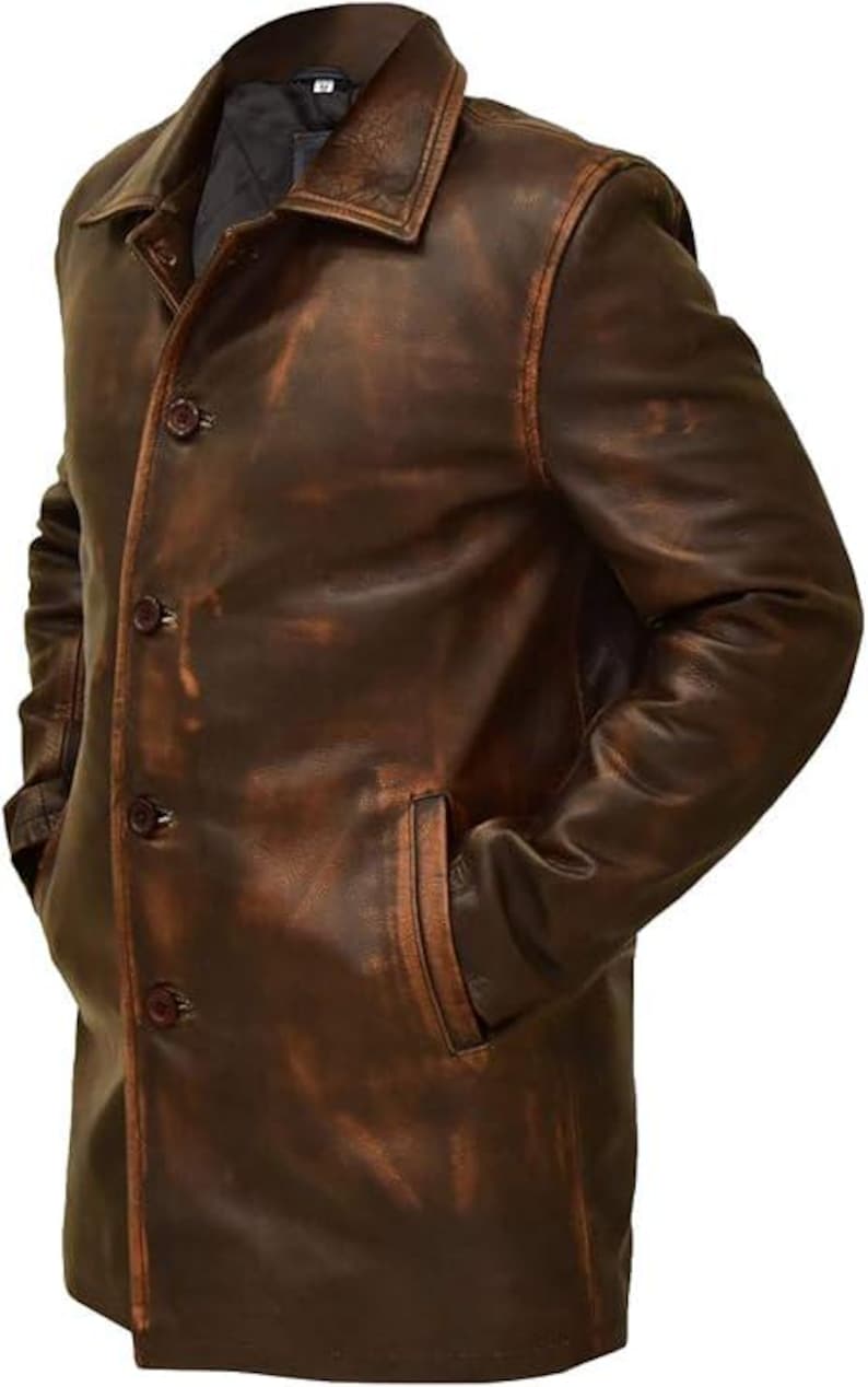 May include: A brown leather jacket with a classic design. The jacket features a button-up front, a collared neckline, and two front pockets. The leather has a distressed appearance, giving it a vintage look. The jacket is a medium length, reaching the mid-thigh.