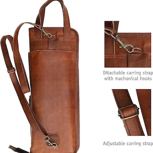 May include: A brown leather quiver with a detachable carrying strap and adjustable strap. The quiver has a handle and metal hardware. The image also shows close-ups of the strap attachments.