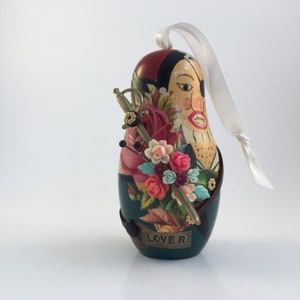 pirate assemblage. repurposed nesting doll hanging art. lover not a fighter. one of a kind and original ornament. found object altered art