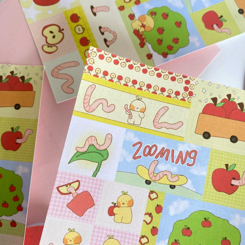 Apple and Worm Sticker Sheet – Cute Kawaii Stickers for Journaling, Scrapbooking, Planners | Lil Things Club Original Art
May include: A sheet of colorful stickers featuring apple and worm illustrations. The stickers have a variety of designs, including apples, worms, and apple trees. Some stickers have the word 'Zooming' on them. The color palette includes red, green, yellow, and blue.