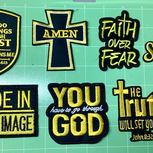 May include: A collection of embroidered patches with religious themes. The patches feature phrases like "Faith Over Fear," "The Lord is my Shepherd," and "Made in God's Image." The patches are black with gold lettering and designs.