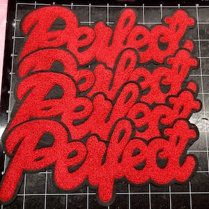 May include: Three red embroidered patches featuring the word Perfect in a cursive script font. Each patch has a thick black border and a textured, fuzzy surface. The patches are arranged in a vertical stack against a black grid background.