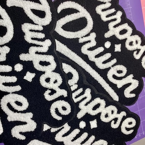 May include: A white ceramic mug with a black handle and the text "But First, Coffee" in a handwritten style. The mug is on a white surface. The mug is approximately 4 inches tall.