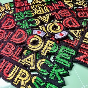 May include: A collection of embroidered patches with the words "BLACK NURSE," "BID," and "DOPE" in red, green, and yellow thread on a black background. The patches feature a variety of fonts and designs, including a nurse's cap.