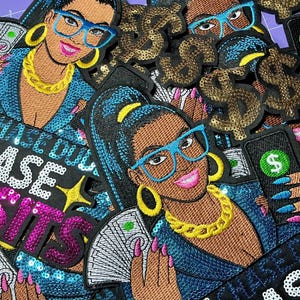 May include: Embroidered patches featuring a woman with glasses, a gold chain, and holding money or a phone with a dollar sign. The patches have a blue, pink, and gold color scheme, with the text "DON'T CHASE DREAMS, CHASE DEPOSITS".