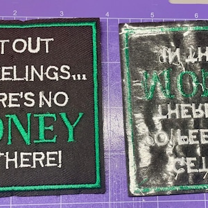 May include: Two embroidered patches. The first is black with white and green text that reads "GET OUT YO' FEELINGS... THERE'S NO MONEY IN THERE!". The second is a mirrored version.