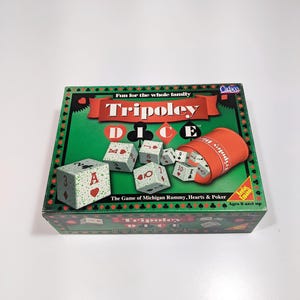 May include: A Tripoley Dice game box with a green background and red banner. The box features dice, a dice cup, and the game's name. The game is for ages 8 and up.