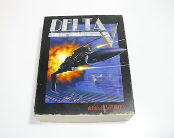 May include: A vintage video game box for "Delta V" featuring a futuristic spaceship design against a backdrop of a fiery sky and a cityscape. The box has the text "DELTA V" and "Bethesda Softworks".