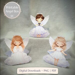 May include: Three angel-themed paper cutouts. Each angel has white wings, a halo, and a white dress. The angels are standing on clouds. The text "Printable Angel Box" is in a circle in the upper left corner. The text "Digital Downloads ~ PNG | PDF" is at the bottom.