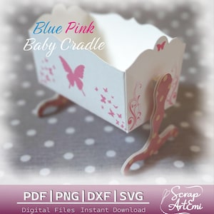 May include: A white baby cradle with pink butterfly and floral designs. The text "Blue Pink Baby Cradle" is displayed on the front. The cradle has curved, pink and white supports. The bottom of the image displays "PDF | PNG | DXF | SVG" and "Digital Files Instant Download".