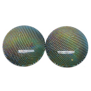 May include: Two iridescent green and blue round glass eyes with a white line across the center. The eyes have a textured surface that resembles scales.