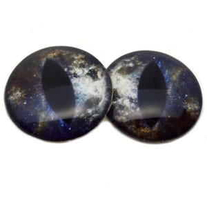 May include: A pair of black and blue cat eyes with a galaxy print. The eyes are round and have a black pupil with a white ring around it.