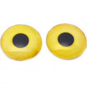 Puede incluir: Dos ojos redondos de plástico amarillo con pupilas negras, comúnmente utilizados para proyectos de manualidades.