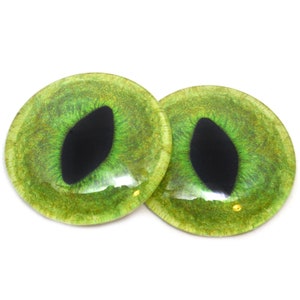 May include: Two green cat eyes with black pupils. The eyes are round and have a glossy finish.