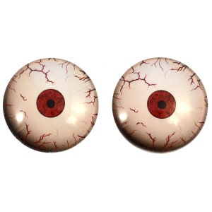 May include: Two realistic-looking glass eyeballs with red pupils and white scleras with red veins. The eyeballs are round and have a glossy finish.
