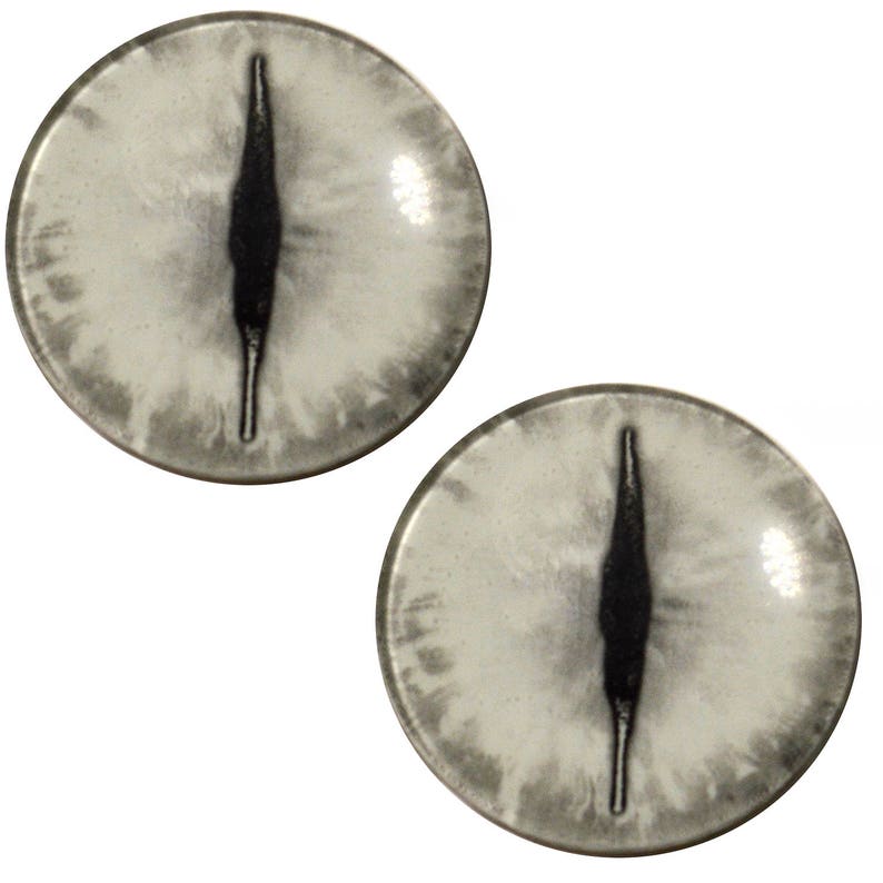 May include: Two white plastic eyes with black pupils, resembling animal eyes. The eyes are round and have a glossy finish.