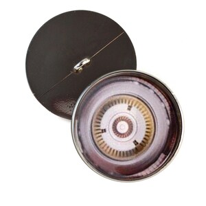 May include: Two-part button with a metallic brown back and a detailed, circular design on the front. The front design features concentric circles in shades of brown, gold, and white, encased in a silver-colored metal rim.