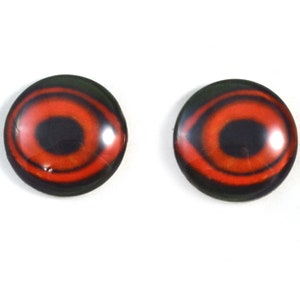 May include: Pair of red and black plastic doll eyes with a black pupil and a green outer ring.