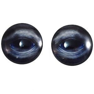 May include: Two round, glass eyes with a dark blue iris and a swirling, galaxy-like pattern. The eyes have a reflective surface, with a bright highlight in the center. The overall effect is a mysterious and captivating look, perfect for crafts.