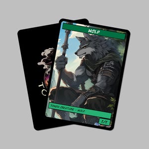 May include: Two fantasy art cards. The primary card features a muscular wolf-like creature holding a staff, with the word "WOLF" at the top. The card is labeled "TOKEN CREATURE - WOLF" and "2/2". The second card is black with a stylized design.