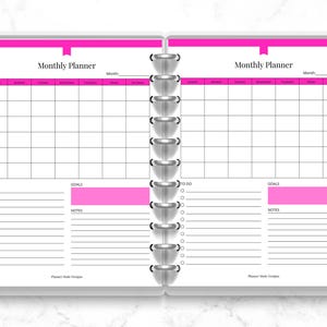 May include: Open planner with a pink and white monthly planner spread. The left page has a section for "To Do" and "Goals", while the right page mirrors this layout. The planner is bound with silver rings and has colorful page dividers.
