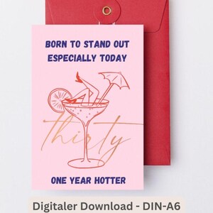 May include: A pink birthday card with a red envelope. The card features a cocktail illustration with legs and an umbrella, and the words "Born to Stand Out Especially Today" and "Thirty One Year Hotter."