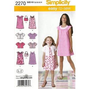 May include: Simplicity sewing pattern 2270 for sizes K5 7, 8, 10, 12, 14. The package features illustrations of various dress and top designs, including options with floral and polka dot patterns, alongside a photo of two models wearing the garments.