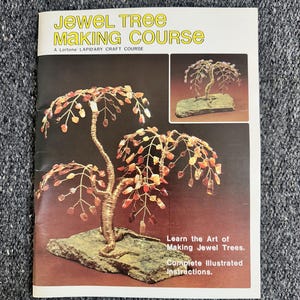 May include: A book titled "JEWEL TREE MAKING COURSE" with illustrations of jewel trees. The cover features a jewel tree with red and orange gemstone leaves and a wire trunk. The text reads "Learn the Art of Making Jewel Trees. Complete Illustrated Instructions."