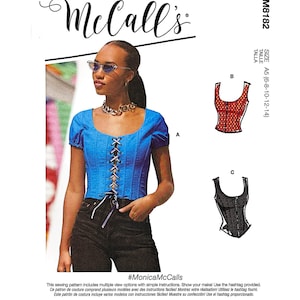 May include: McCall's M8182 sewing pattern envelope featuring a blue corset-style top with short puff sleeves and a front lace-up closure. The pattern includes size range A5 (6-8-10-12-14) and displays two additional garment variations labeled B and C.