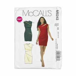 May include: A McCalls M6243 sewing pattern envelope featuring a red sleeveless dress with a cutout neckline. The package displays illustrations of two additional dress variations in dark green and light yellow, both featuring diagonal zipper details.